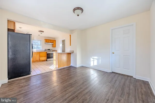 a view of a kitchen with wooden floor and a sink