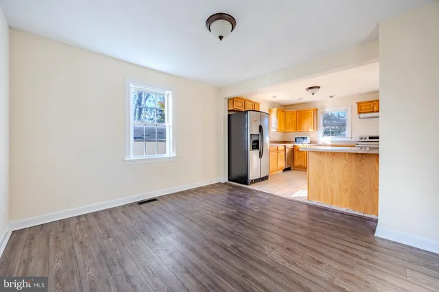 a view of a kitchen with a sink and wooden floor