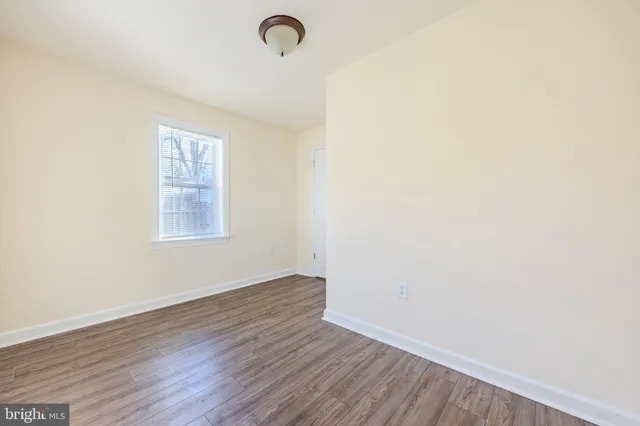 a view of a room with wooden floor and small cabinets