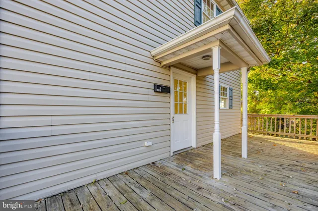 a view of a house with wooden deck
