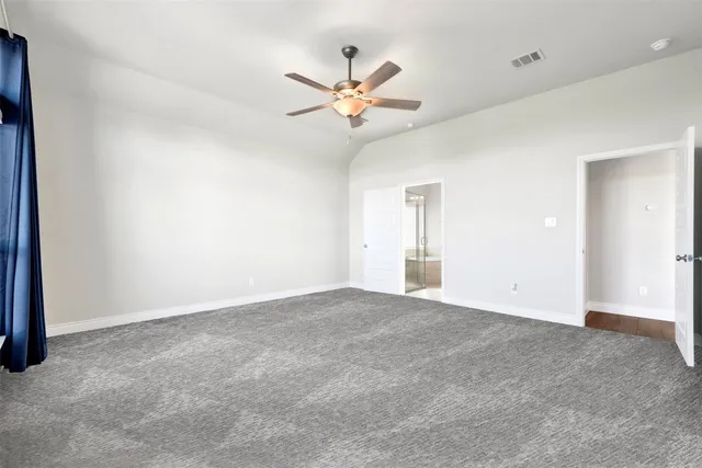 a view of an empty room with a ceiling fan