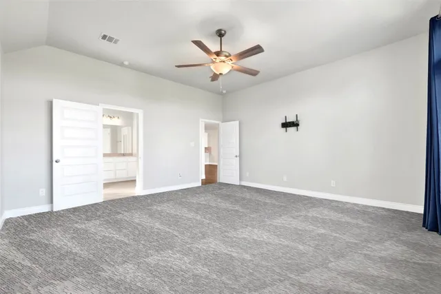 a view of an empty room with a ceiling fan