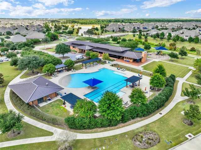 an aerial view of residential houses and outdoor space