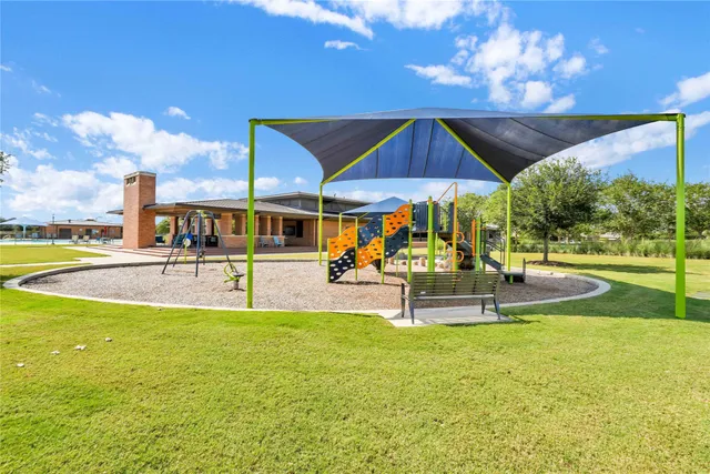 a view of a swimming pool with an outdoor seating and a yard
