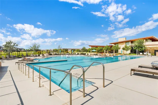 a view of swimming pool with outdoor seating and wooden floor