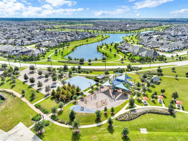 a view of a swimming pool with a lot of trees in front of it