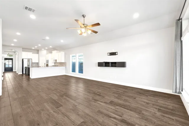 a view of a kitchen with a sink and a ceiling fan