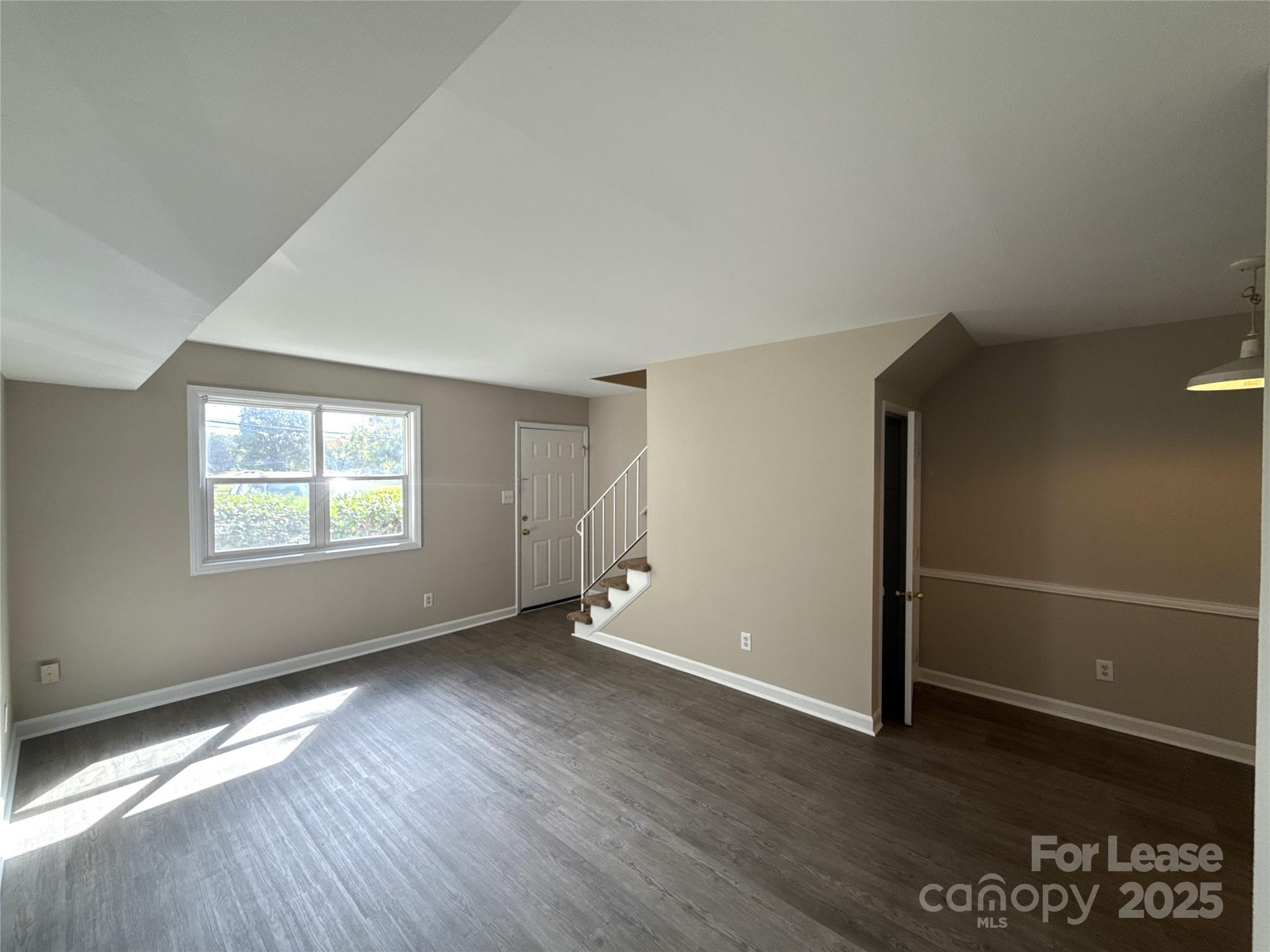 1613 North Sharon Amity Road, Unit G Charlotte, NC 28205 - Photo 3 of 12 an empty room with wooden floor and windows