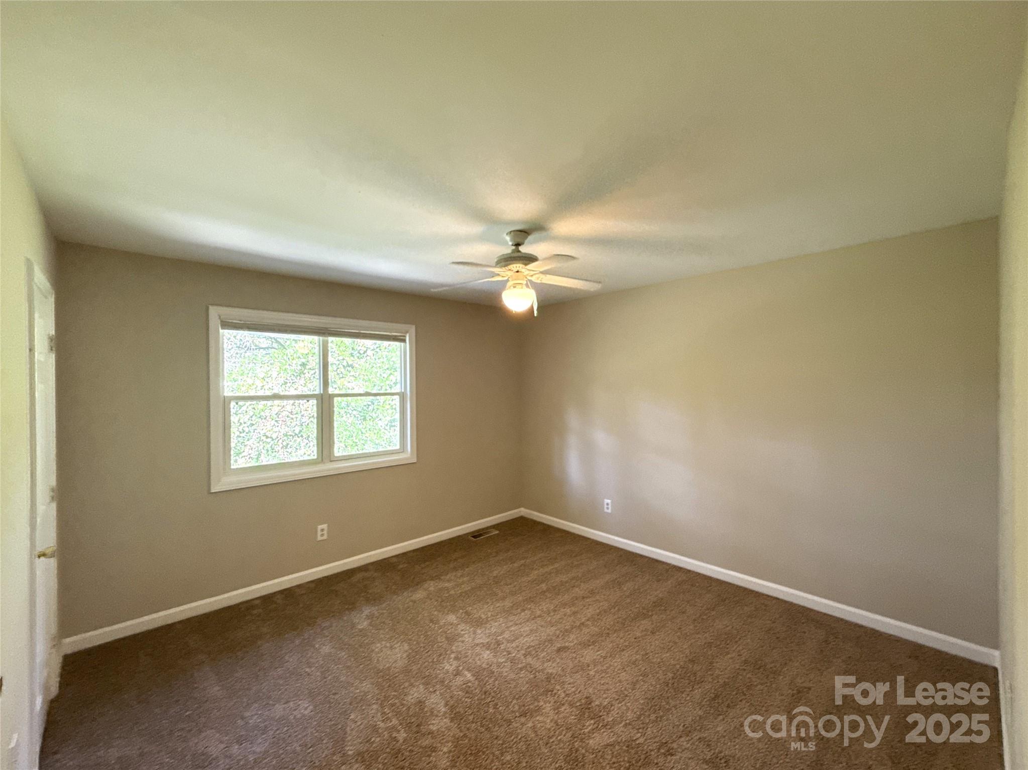 1613 North Sharon Amity Road, Unit G Charlotte, NC 28205 - Photo 8 of 12 an empty room with a window