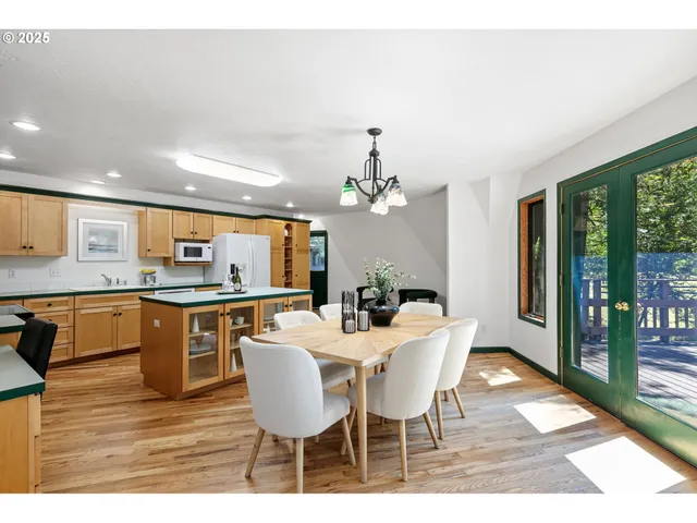 a dining room with wooden floor and window