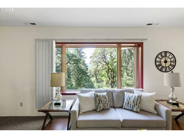 a living room with furniture a window and a table