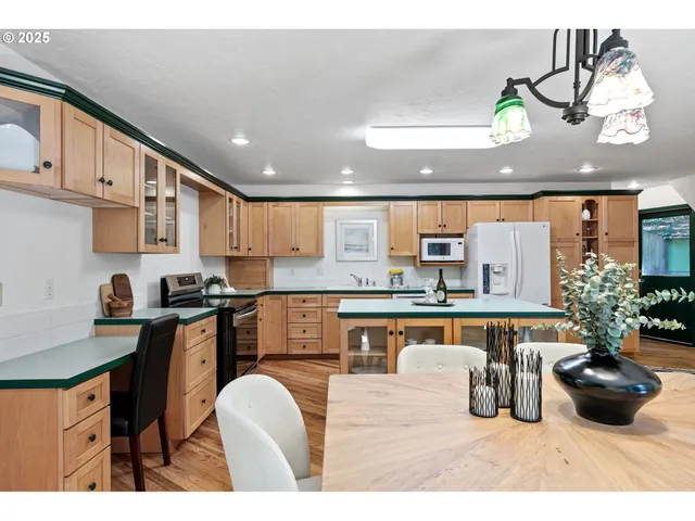 a kitchen with stainless steel appliances granite countertop a lot of cabinets a sink and a stove