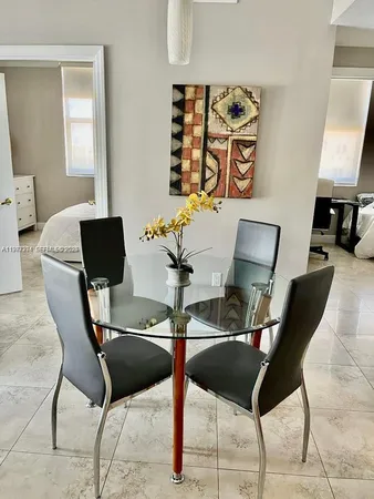 a living room with furniture and painting on the wall