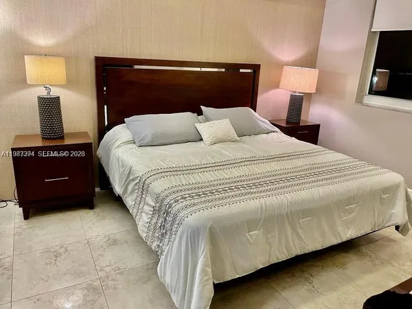 a bedroom with a bed and a television