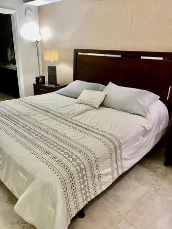a large bed sitting in a bedroom and dresser