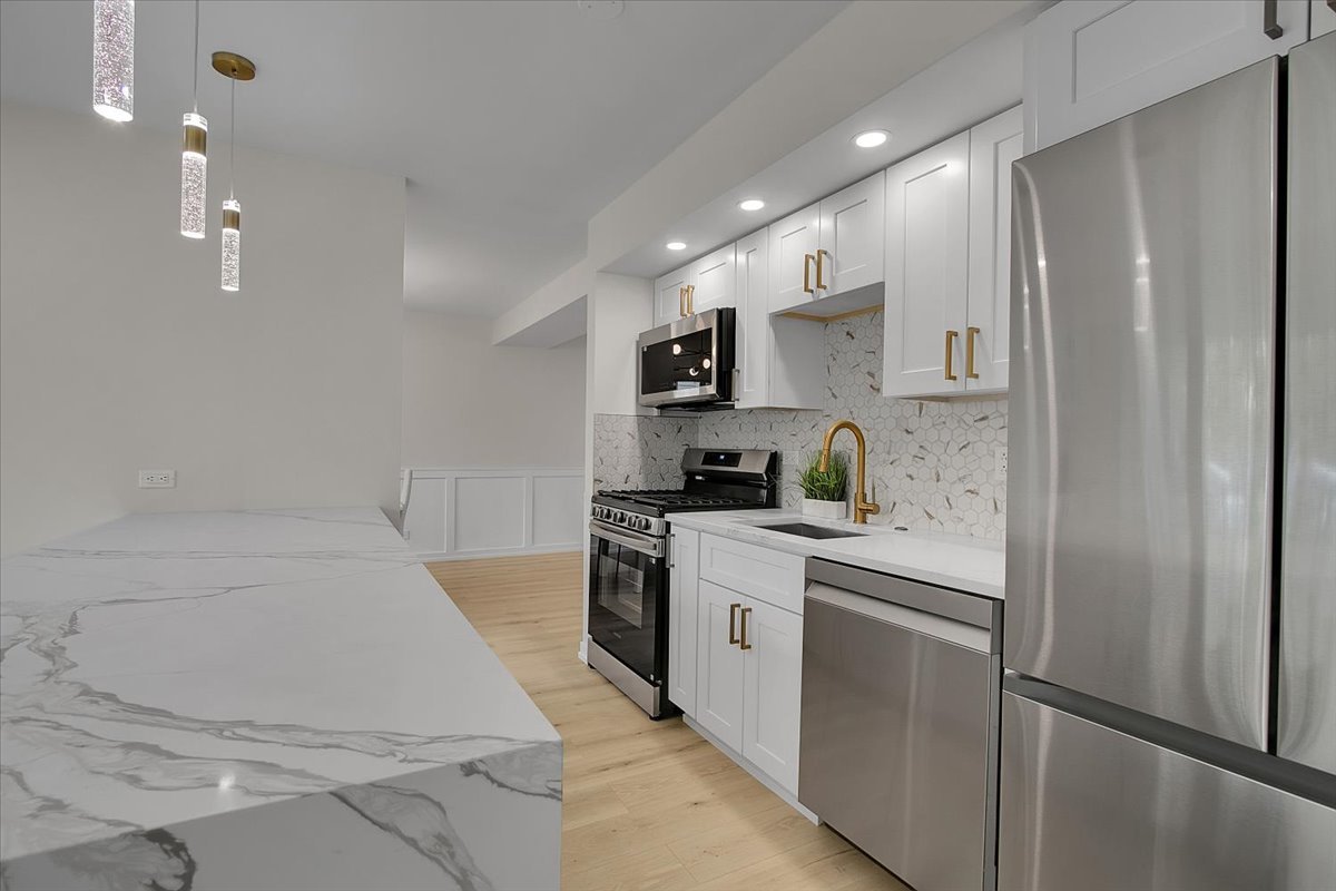 1109 71st Street Darien, IL 60561 - Photo 18 of 41 a kitchen with a sink stainless steel appliances and cabinets