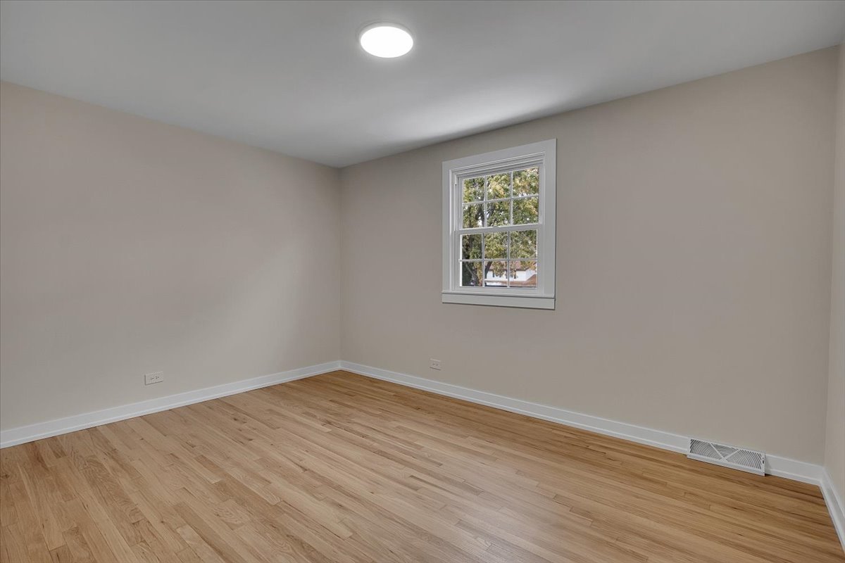 1109 71st Street Darien, IL 60561 - Photo 29 of 41 an empty room with wooden floor and windows