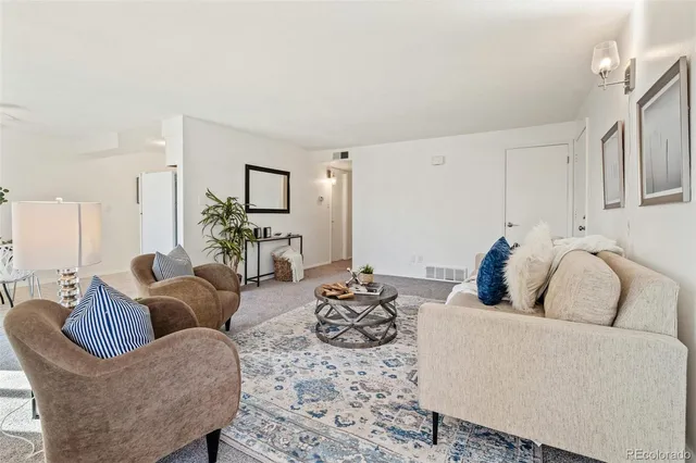a living room with furniture and a large mirror