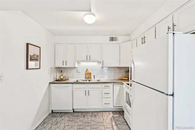 a kitchen with stainless steel appliances a refrigerator sink and cabinets