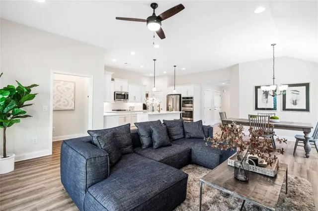 a view of living room kitchen with stainless steel appliances