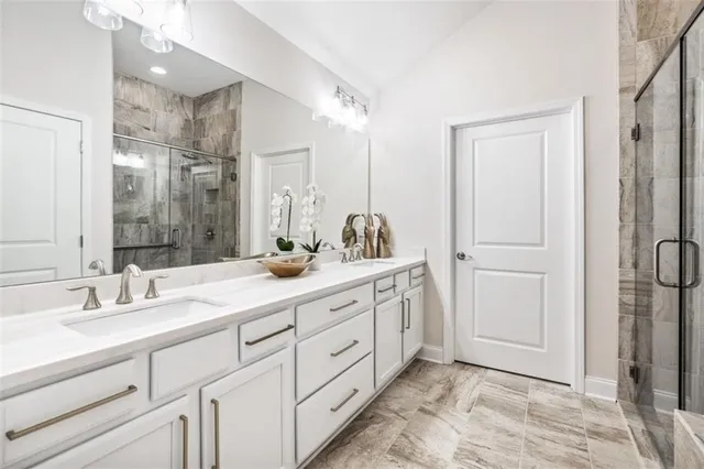 a spacious bathroom with a double vanity sink mirror and double