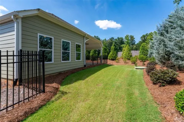 a view of a house with backyard and porch