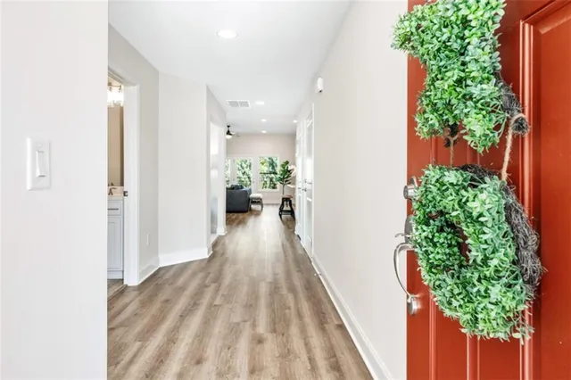 a view of a hallway with wooden floor and plants
