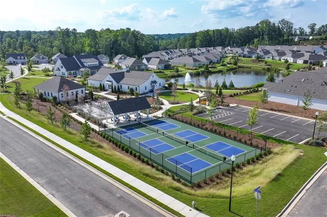 an aerial view of a resort with swimming pool and outdoor seating