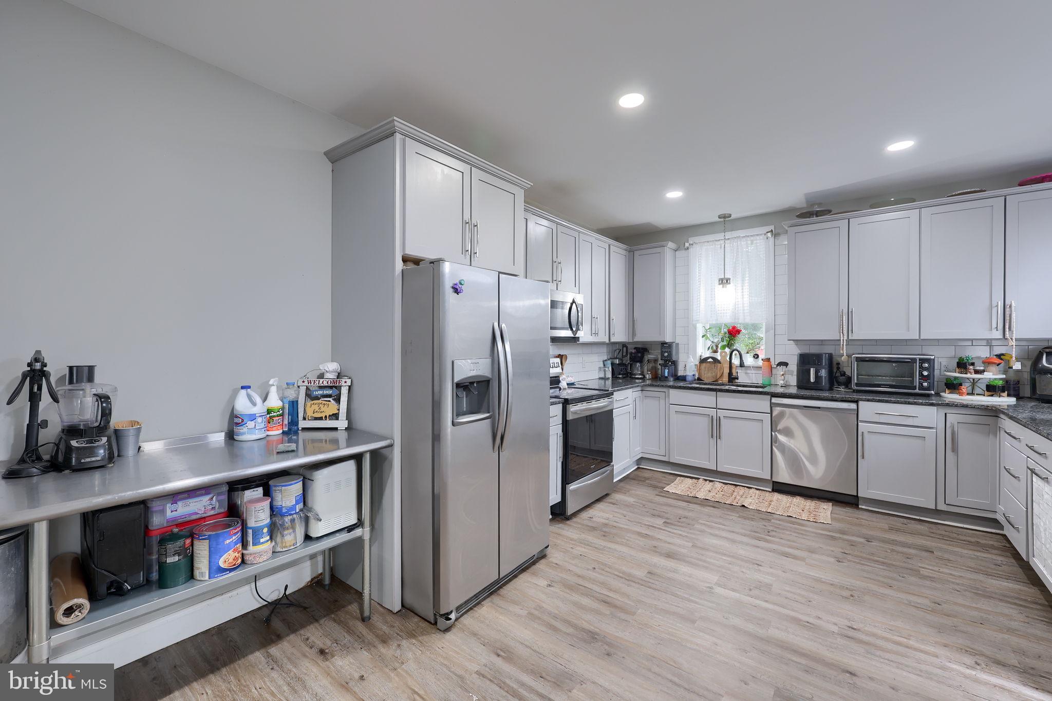 332 Perry Street Columbia, PA 17512 - Photo 12 of 37 a kitchen with refrigerator a microwave and wooden floor