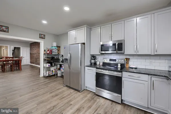 a kitchen with stainless steel appliances a refrigerator stove and sink