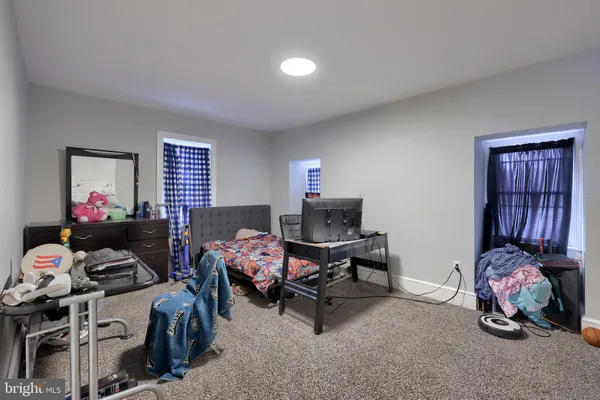 a bedroom with furniture and a window