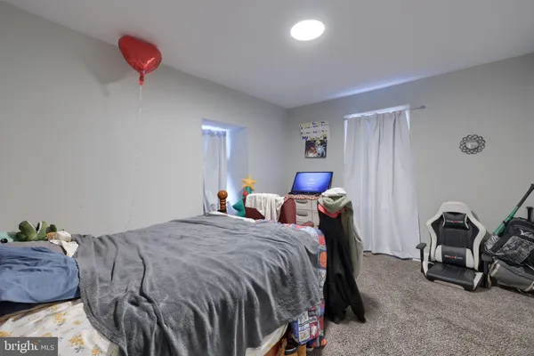 a bedroom with a bed and a lamp