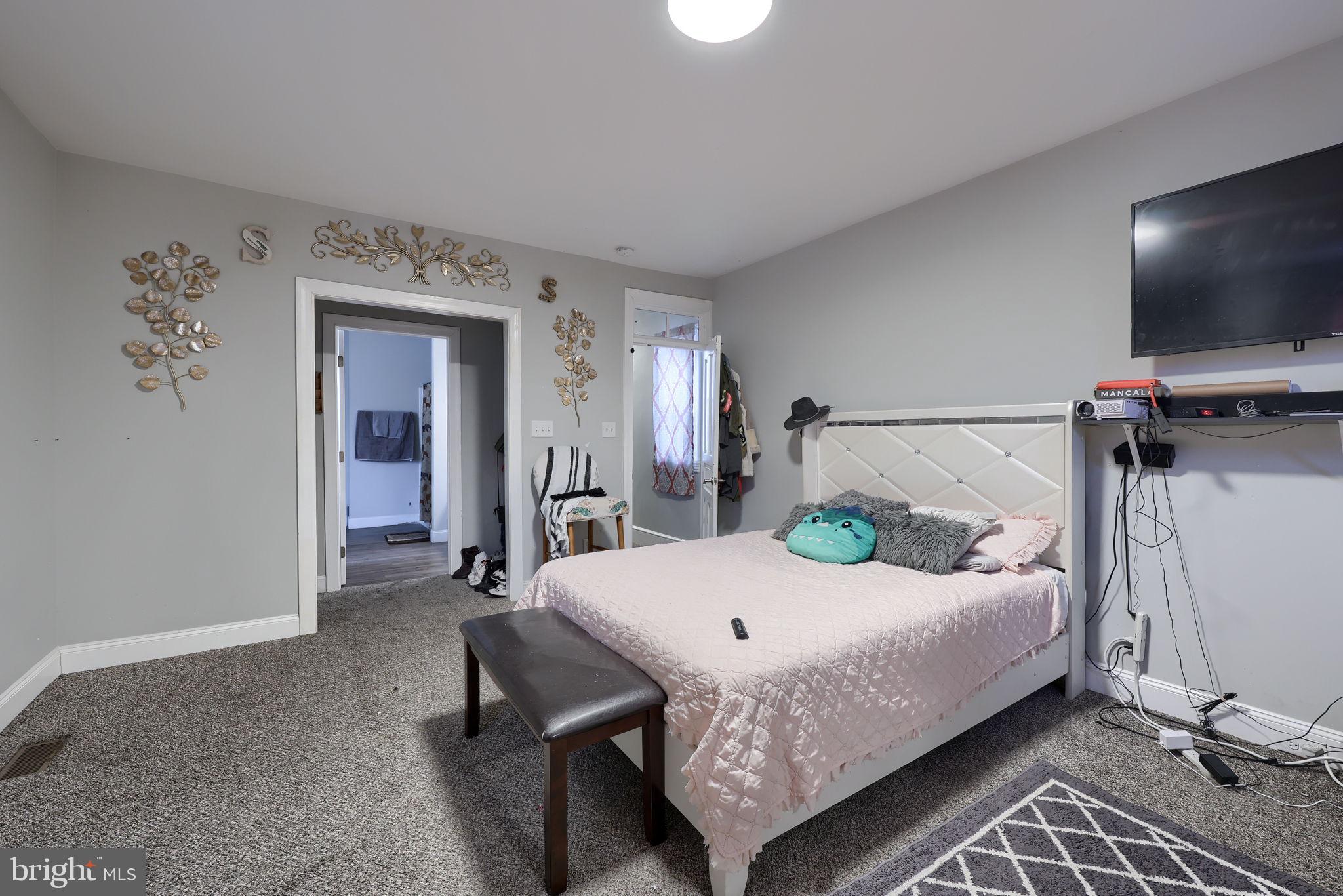 332 Perry Street Columbia, PA 17512 - Photo 22 of 37 a bedroom with a bed and large flat screen tv
