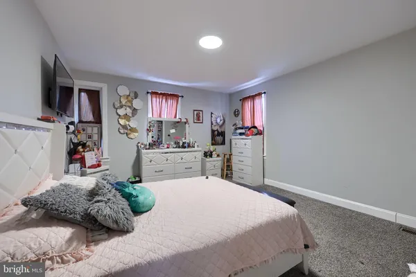 a bedroom with a bed window and walk in closet