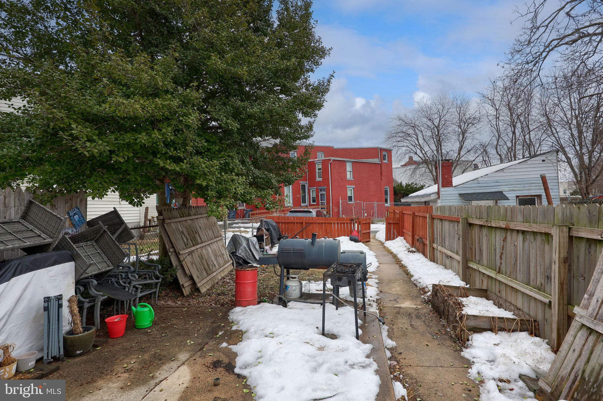 332 Perry Street Columbia, PA 17512 - Photo 35 of 37 a view of a patio with table and chairs a barbeque with wooden fence and plants