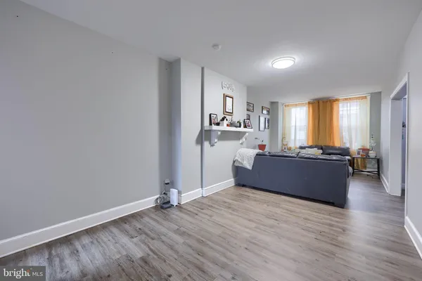 a living room with hard wood floors and a ceiling fan