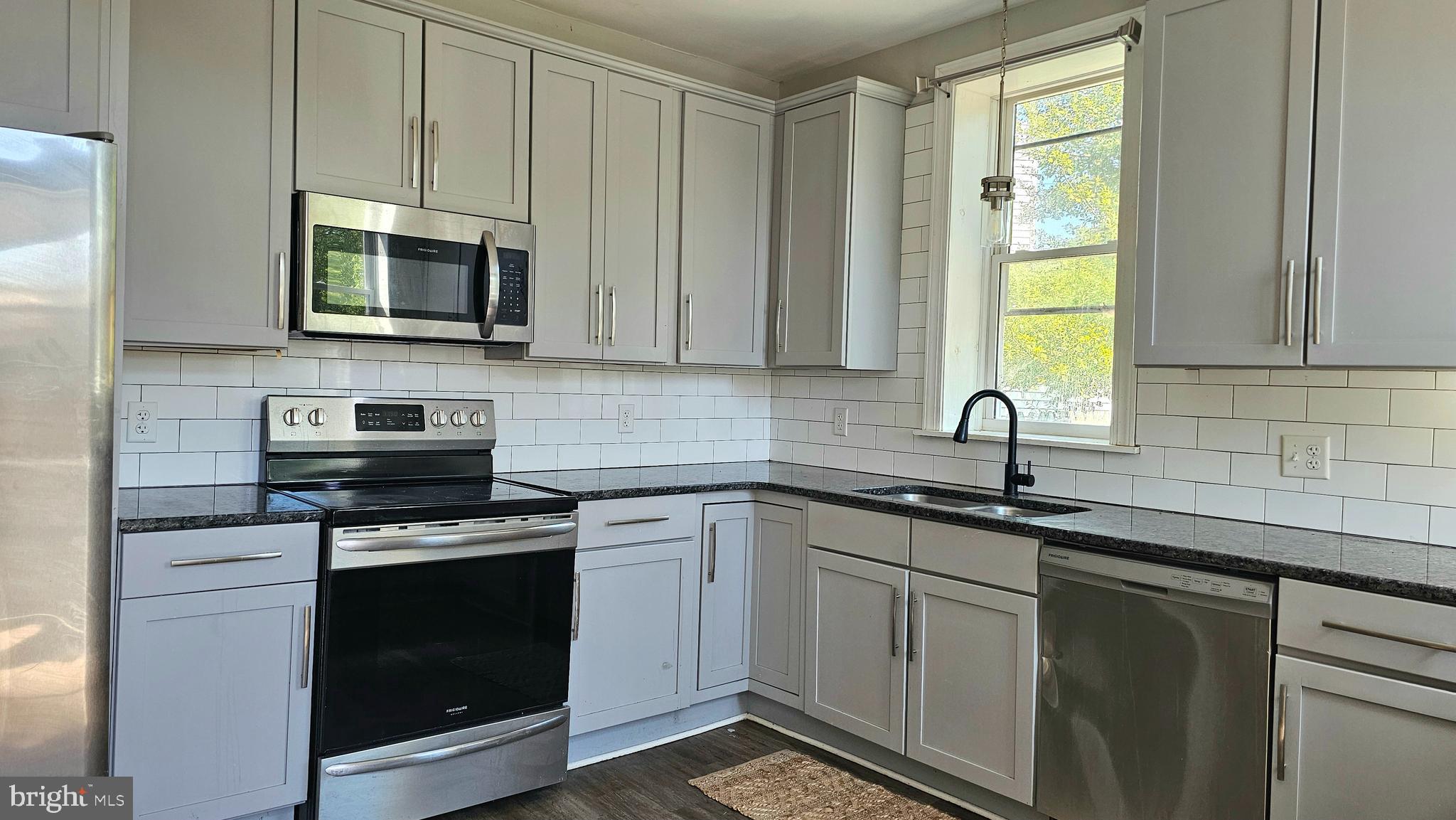 332 Perry Street Columbia, PA 17512 - Photo 7 of 31 a kitchen with white cabinets and a stove top oven