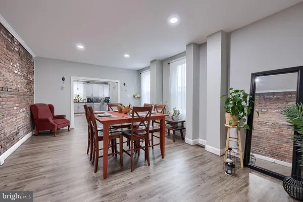 a view of a a dining room with furniture window and wooden floor