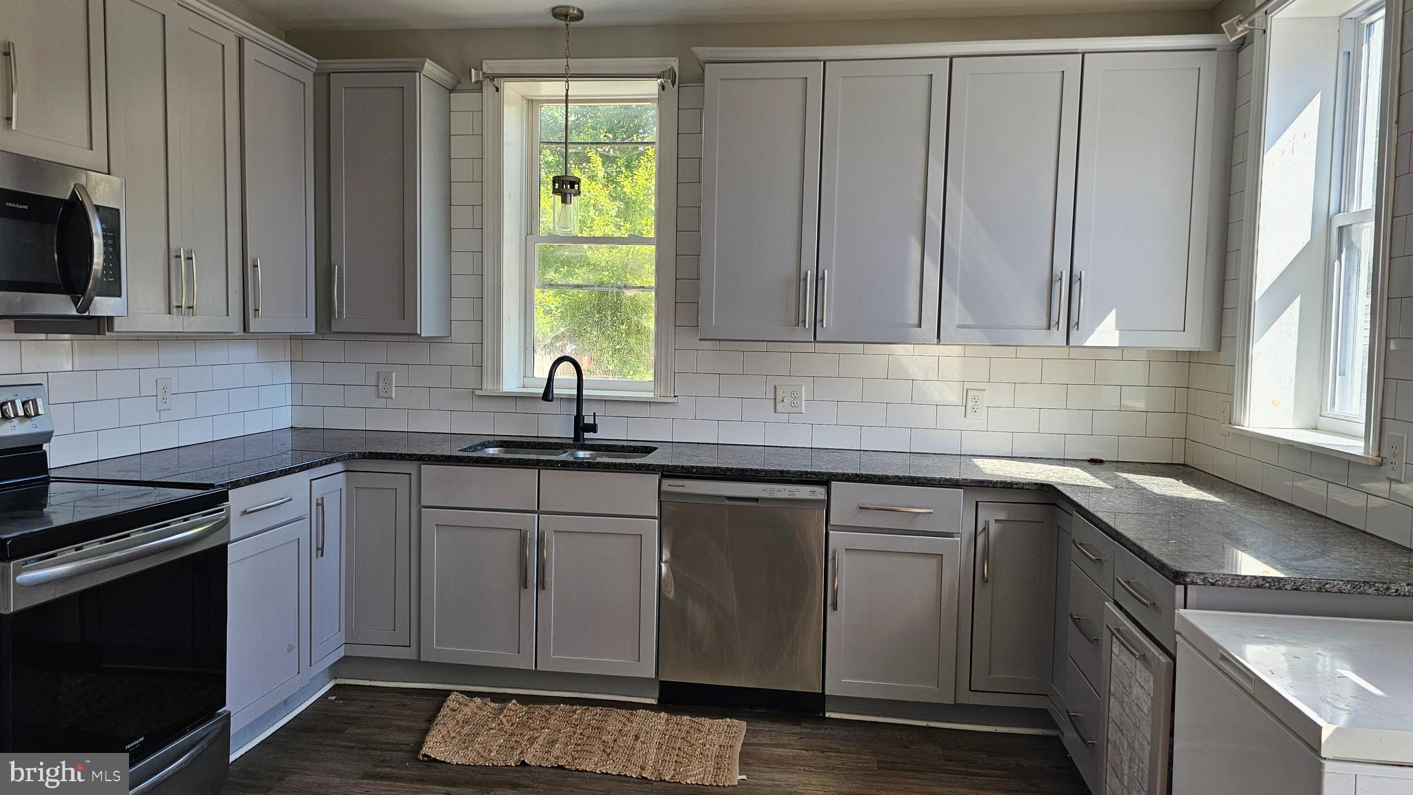 332 Perry Street Columbia, PA 17512 - Photo 9 of 31 a kitchen with stainless steel appliances granite countertop a sink a stove and a microwave