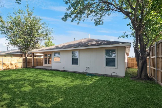 a front view of house with yard and trees