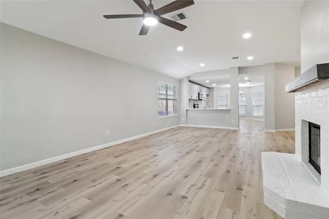 a view of an empty room with a fireplace
