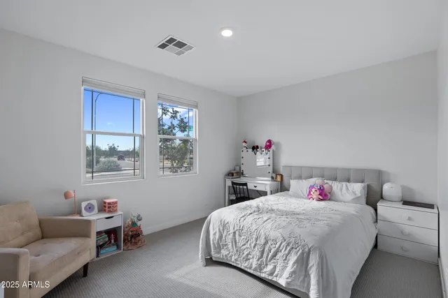 a bedroom with a bed furniture and a window