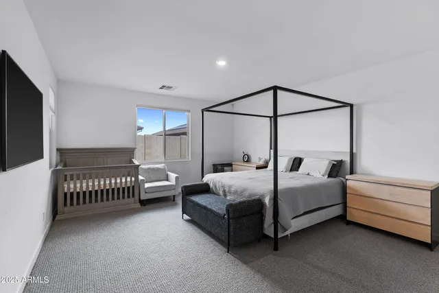 a bedroom with bed and a window