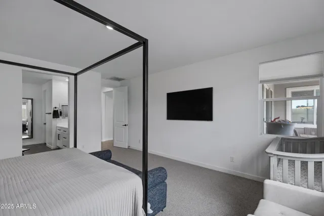 a bedroom with a bed and a flat screen tv