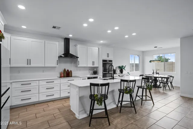 a view of kitchen with cabinets table and chairs