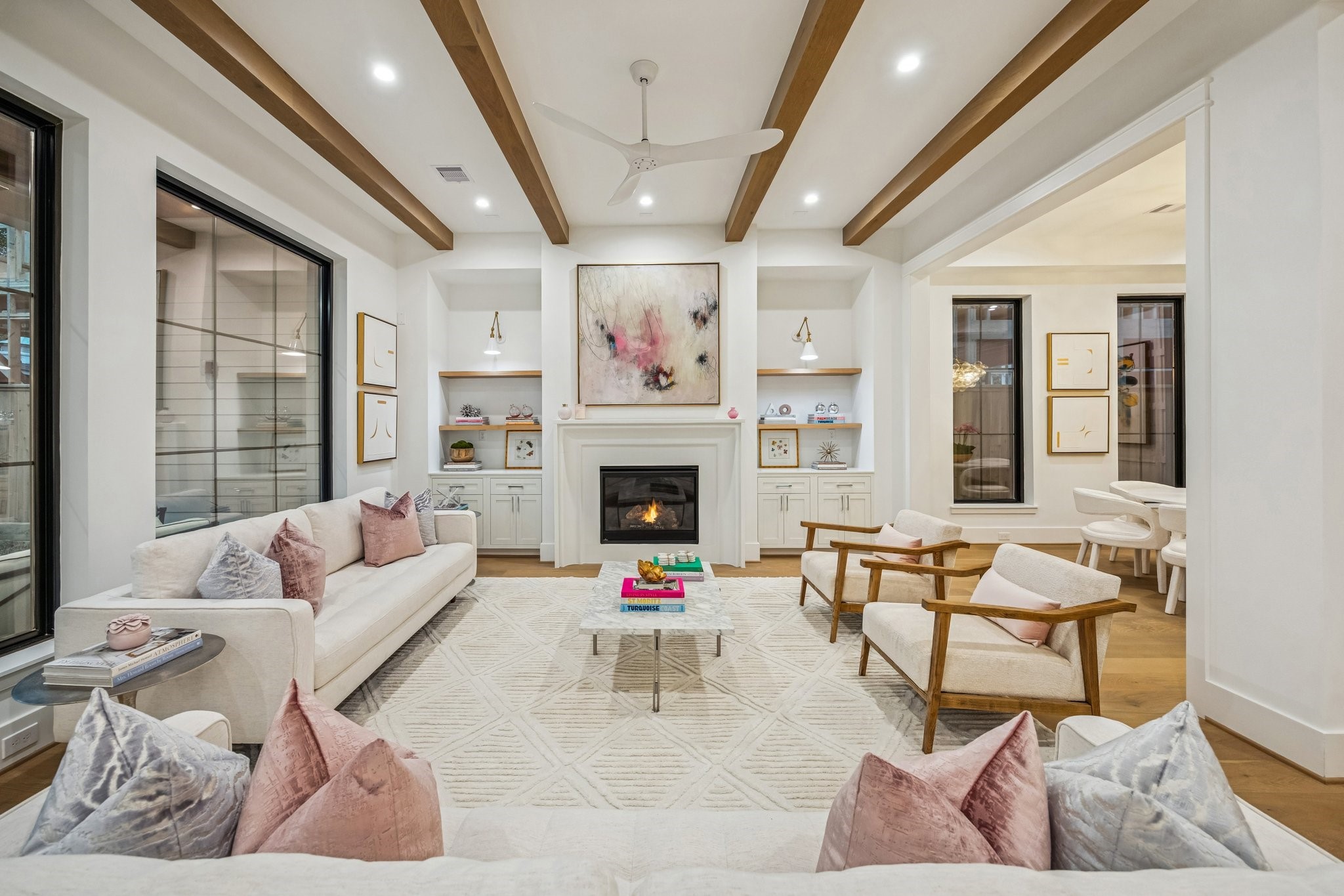 1204 West Drew Street Houston, TX 77006 - Photo 10 of 32 Another view of the Family Room with 42 Inch Direct Vent Gas Fireplace, Cast Stone Surround, Inset, Shaker Style Cabinets/Drawers, White Oak Floating Shelves with a Natural Stain, and Two Anabiya Iron Swing Arm Sconces with White/Brass Gold Finish.