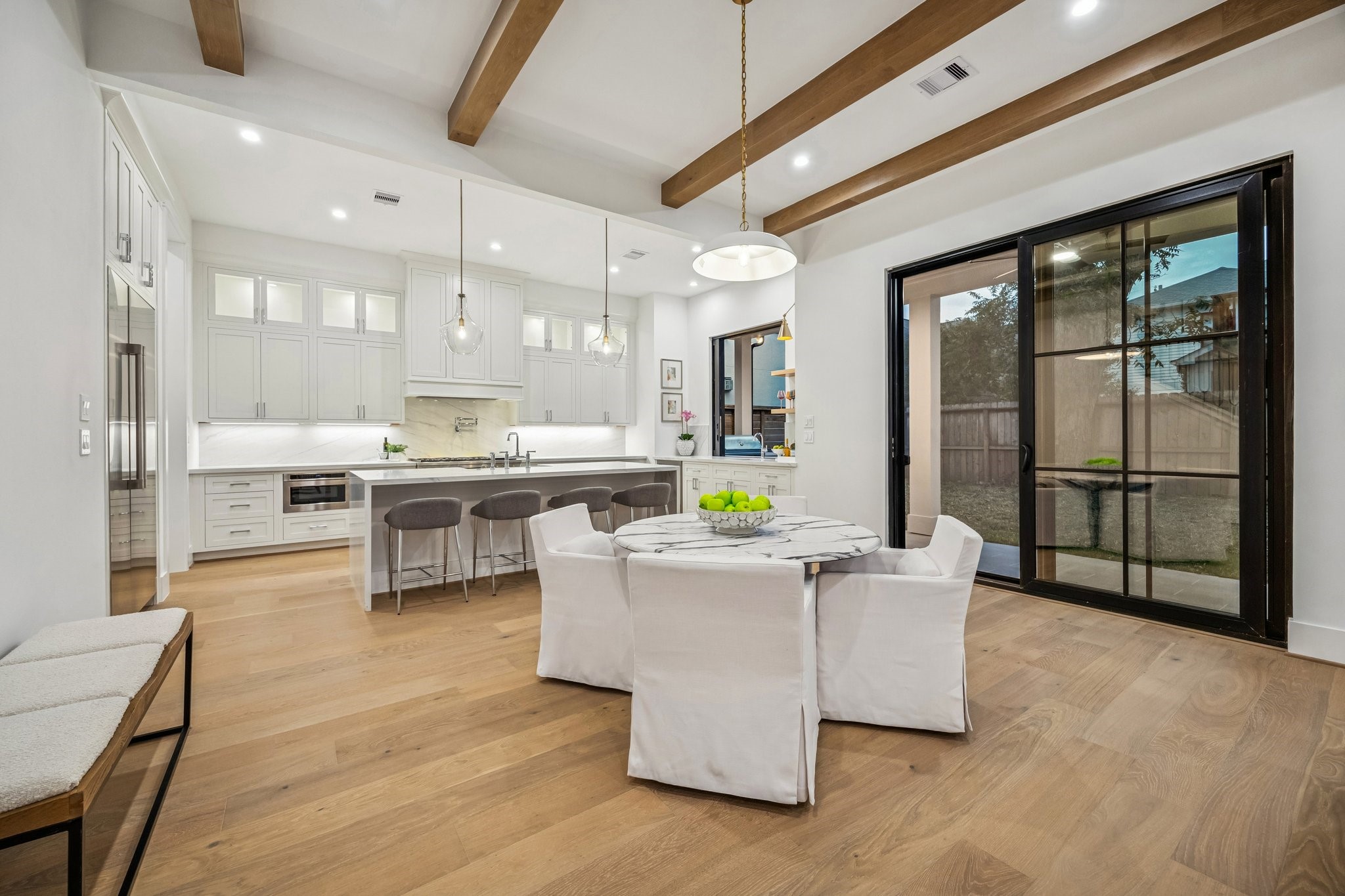1204 West Drew Street Houston, TX 77006 - Photo 13 of 32 Breakfast Area with a 20" Wide Burnished Brass Bowl Pendant Light. There is a set of sliding doors that lead out the covered patio and a large yard with room enough for a pool.