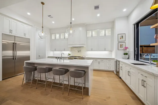 a living room with stainless steel appliances kitchen island granite countertop furniture and a kitchen view