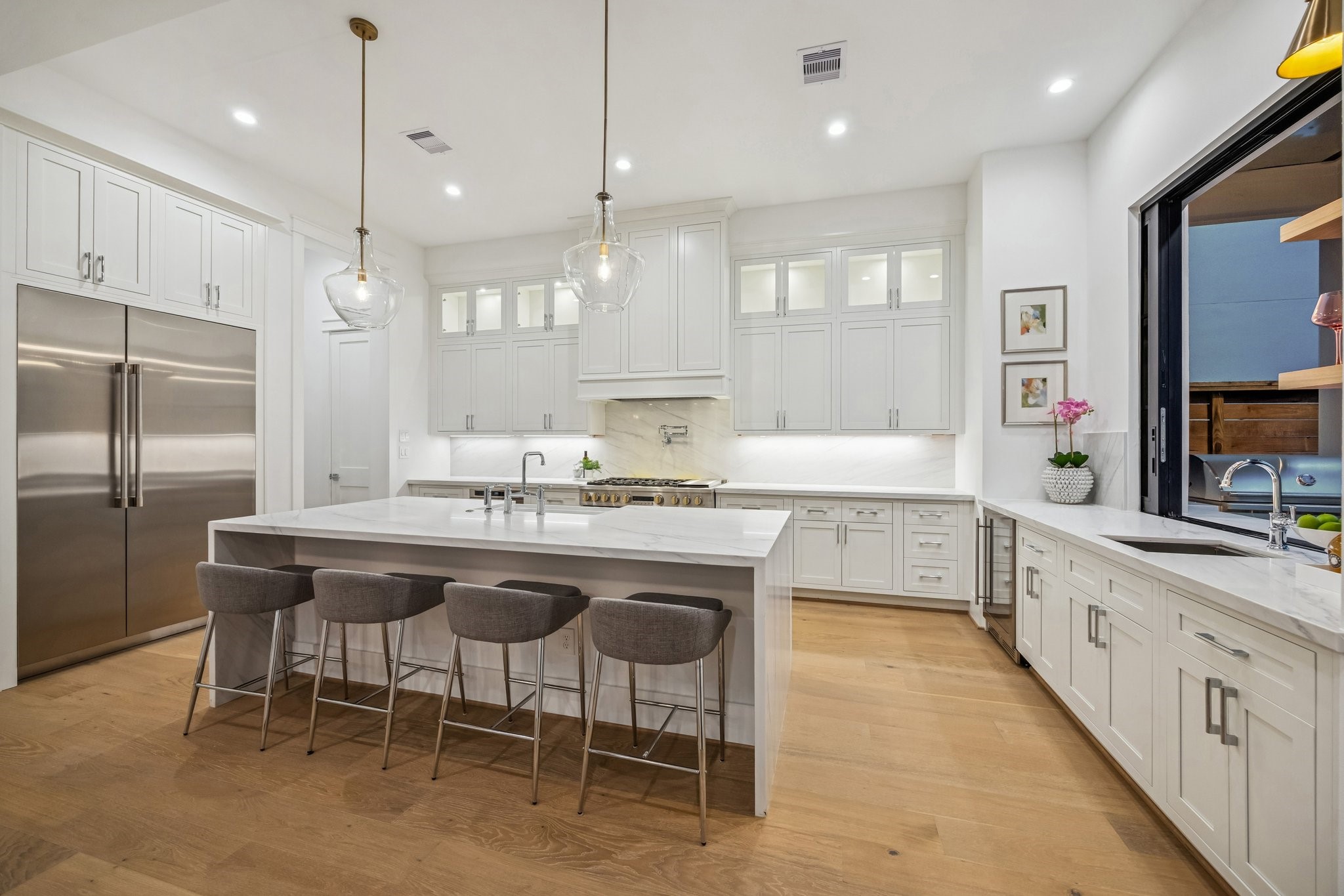 1204 West Drew Street Houston, TX 77006 - Photo 14 of 32 Island Kitchen with Breakfast Bar Seating, Slab Quartz Counter/Side Returns, Two Possini Euro Glass Modern Pendants. There is an Incredible Appliance Package Including: GE Profile Slide-In Range with 6 Burners, Griddle and Double Ovens. There is also a Hood with a GE Profile Stainless Steel Liner, a GE Profile Drawer Microwave, GE Profile Panel Ready Built-In Dishwasher. Also included is a GE Profile Panel Ready Refrigerator/Freezer.
