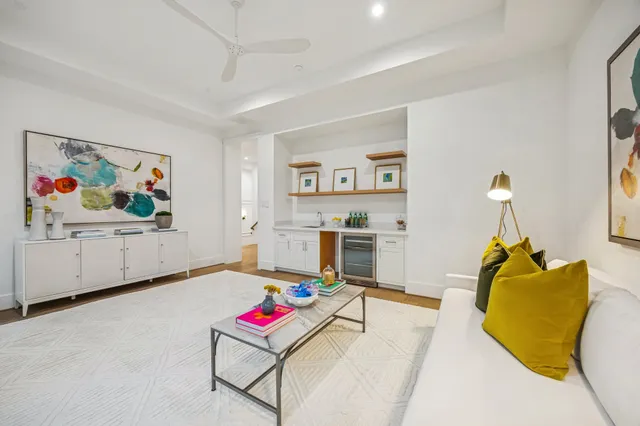a living room with furniture and kitchen view